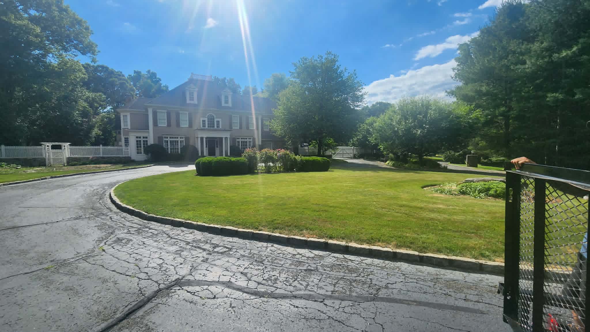 A large Fairfield County home with a maintained lawn and circular drive